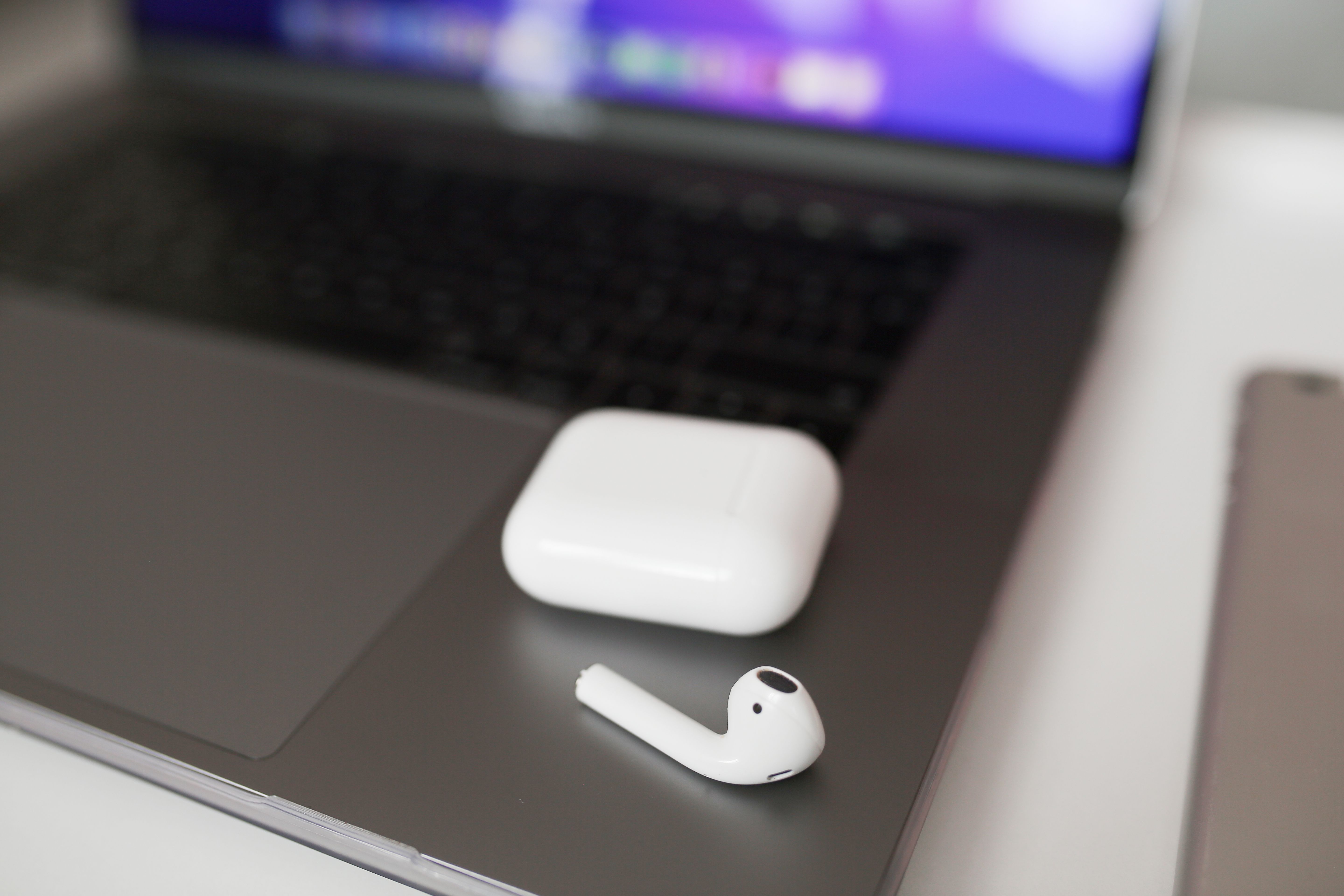 Close-up of a charging cable connected to a small white electronic device