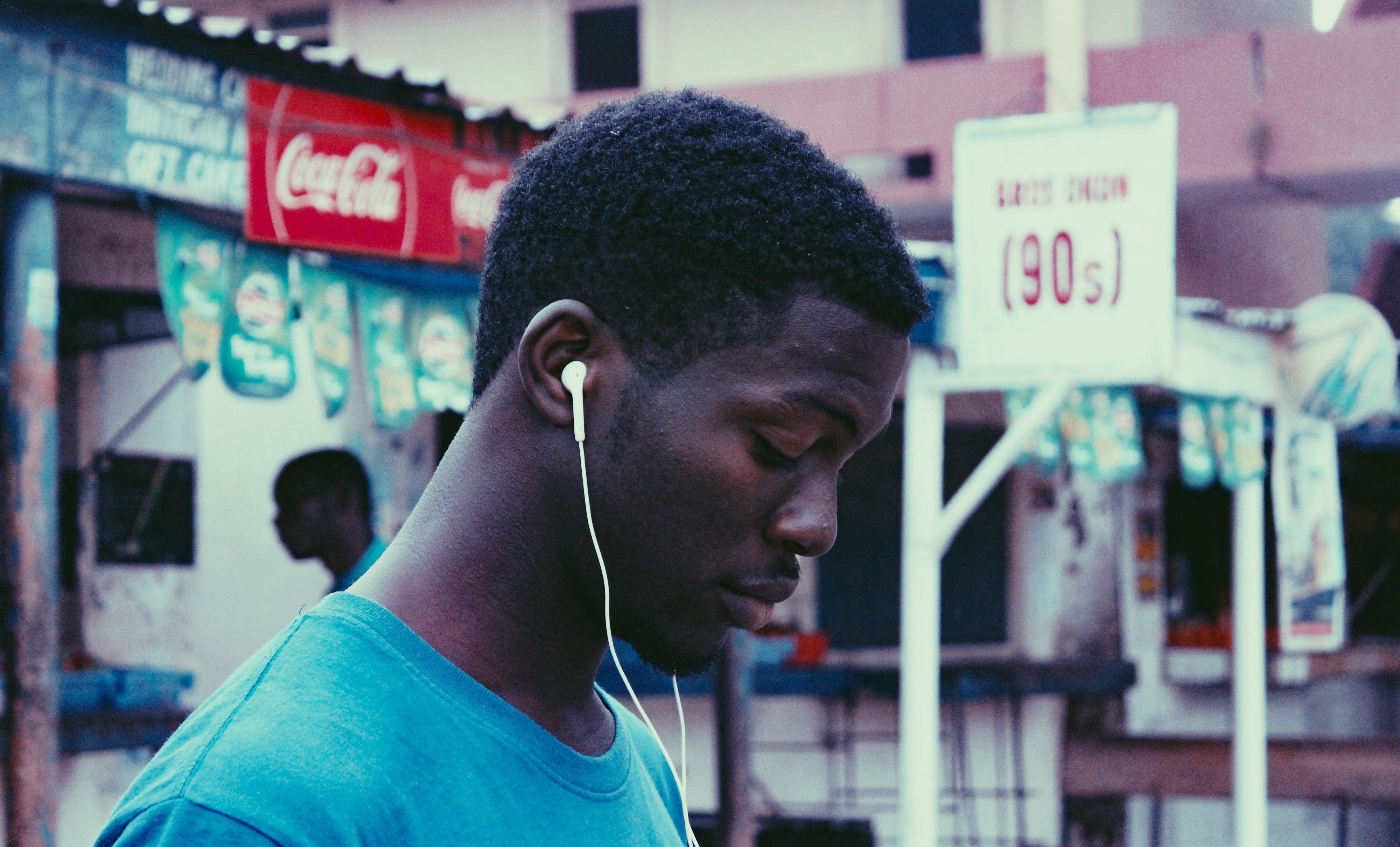Person relaxing with wireless earbuds in while looking at a phone screen